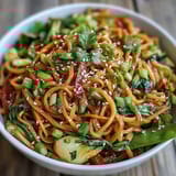 Healthy, low-carb vegan shirataki noodle bowl topped with toasted sesame seeds and fresh green onions for extra crunch.