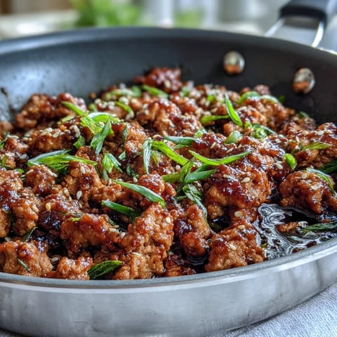 Sizzling Korean-Style Ground Turkey with garlic and ginger in a glossy, spicy-sweet sauce in a skillet.
