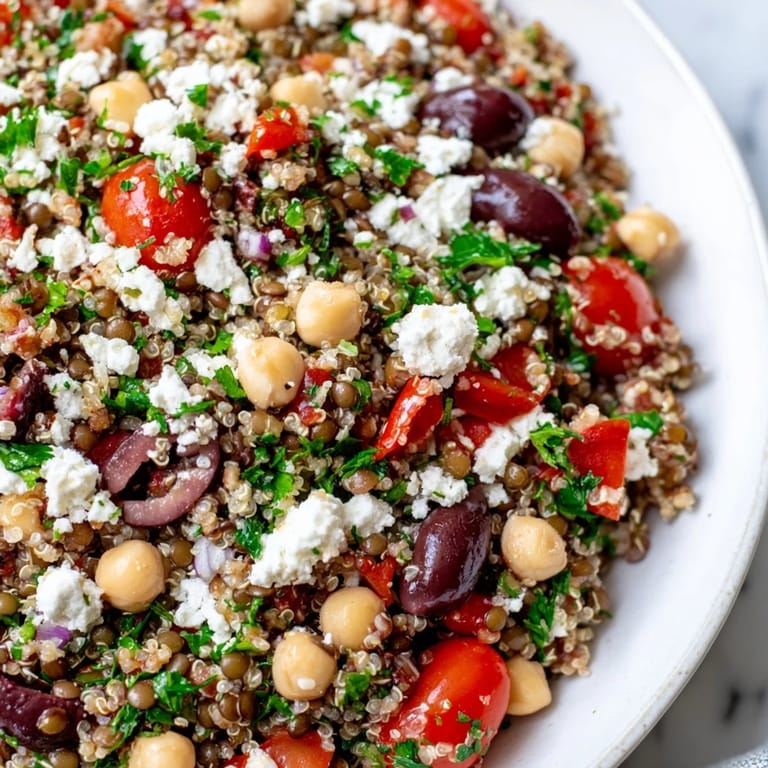A protein-packed Greek Power Salad made with lentils and quinoa, drizzled with a homemade vinaigrette and served as a light dinner.