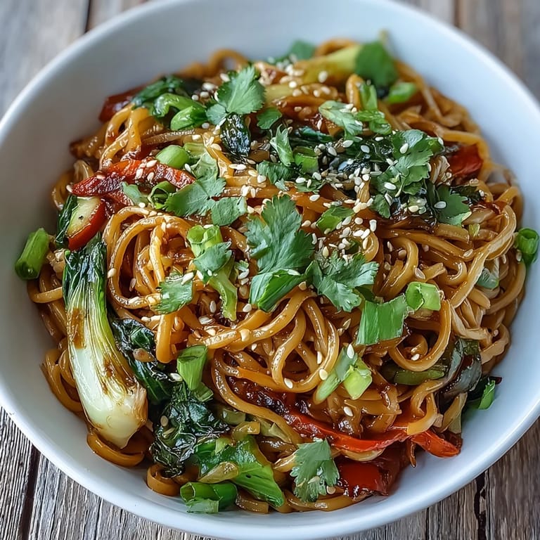 Quick Asian fusion stir-fry featuring shirataki noodles, snow peas, and vibrant vegetables drizzled with savory ginger tamari sauce.